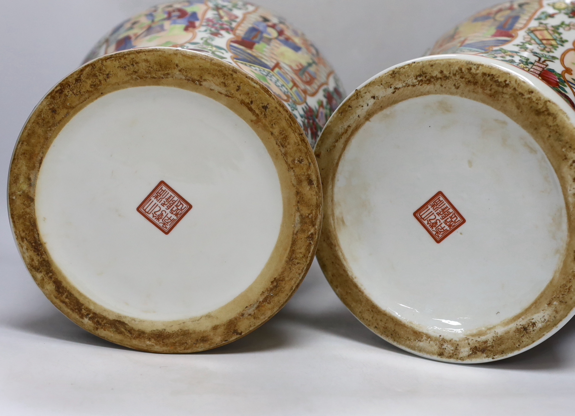 A pair of Chinese famille rose lidded vases, 49cm high